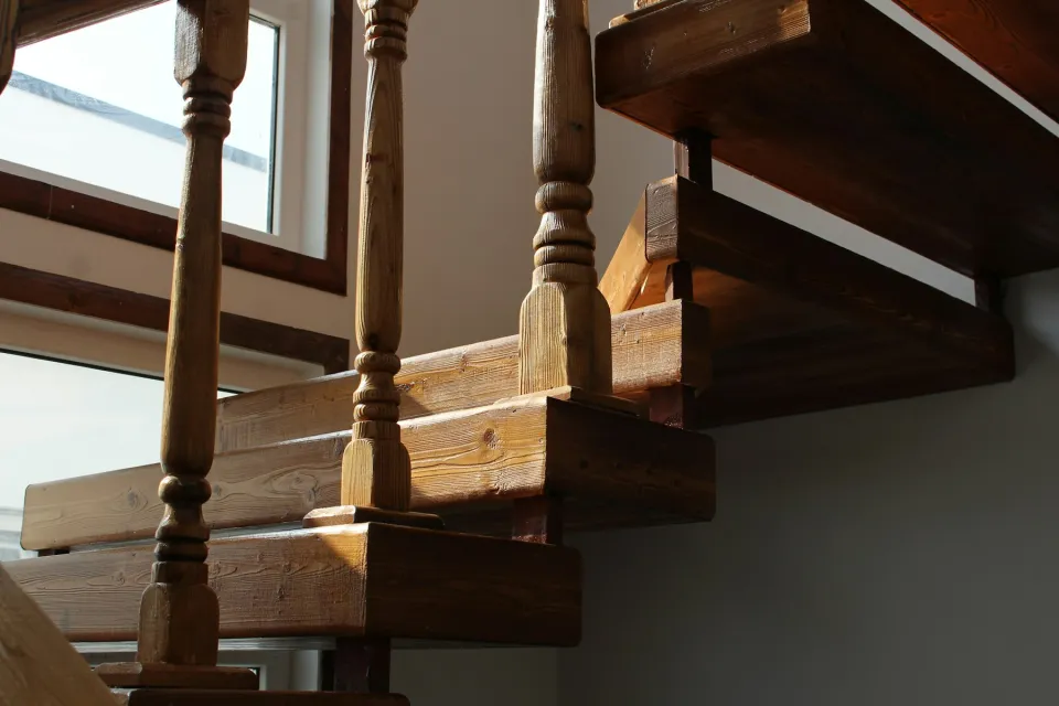 Wooden staircase with turned balusters and a handrail