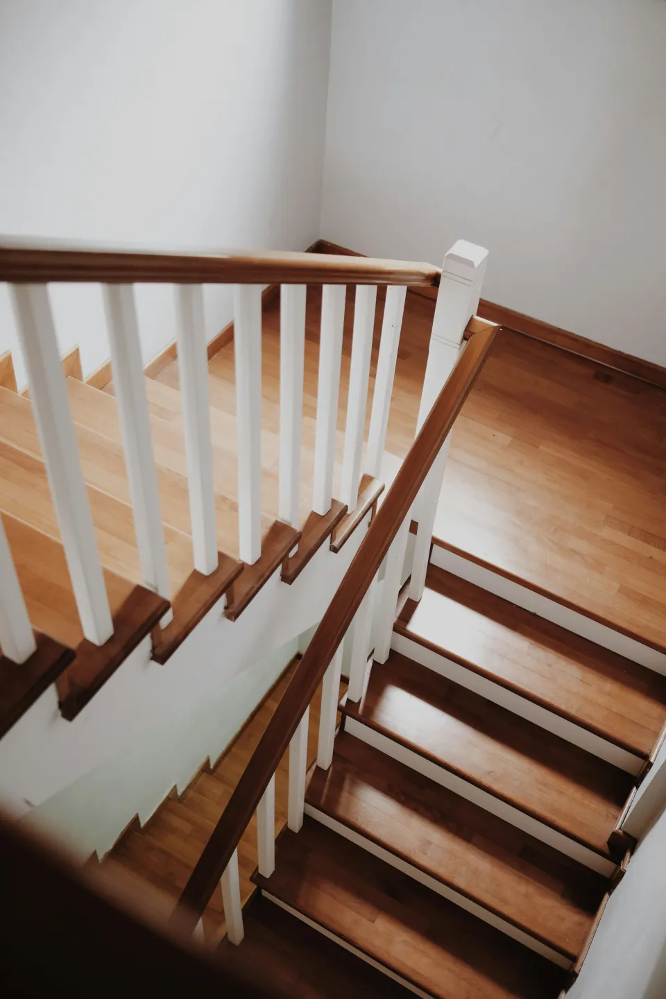 Wooden staircase with a white railing and spindles