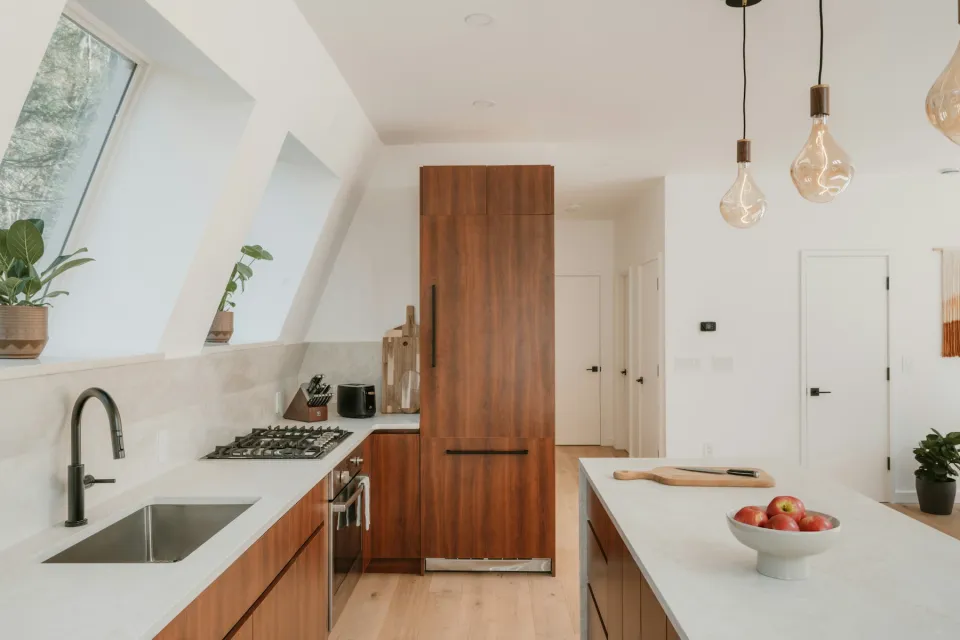 Modern kitchen with wooden cabinets and a white worktop island